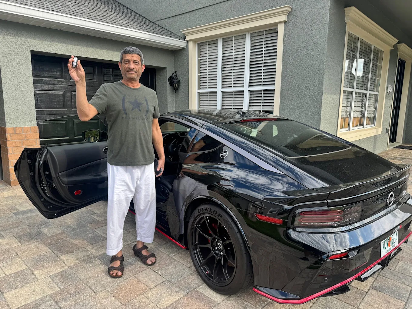 Orlando customer with a replacement key fob beside his car